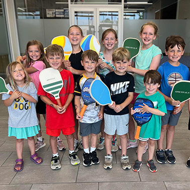Smiling children take a break from playing pickleball to pose for a picture at the new Priceville Event Center.