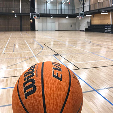 A basketball sits on the floor of the empty basketball court in the state-of-the-art Priceville Event Center.
