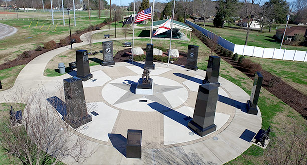 A drone view of the Veterans Memorial with flags flying half mast in Veterans Memorial Park in Priceville, AL.